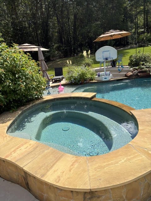 Raised stone spa with clear water after a cleaning visit